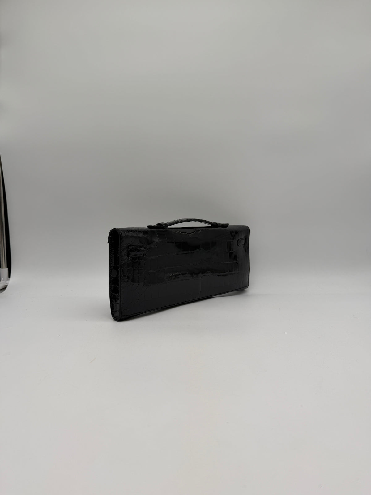 Hermès Kelly Cut Black Shiny Porosus Palladium Hardware